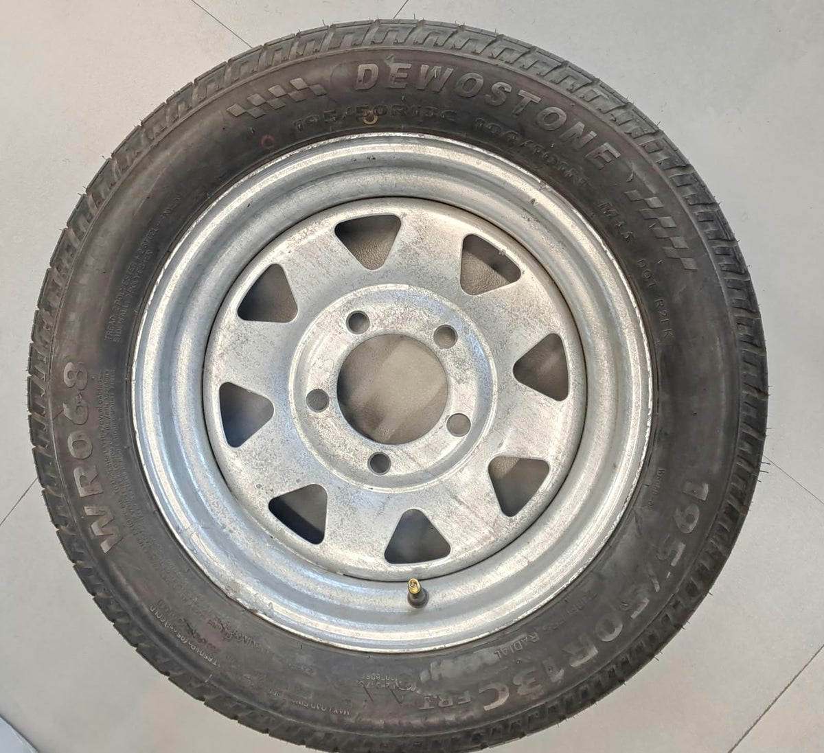 Trailer spare wheel with 195/50R13C tire on galvanized five-lug rim